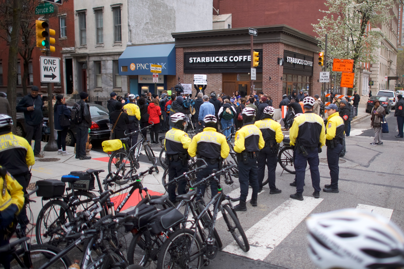Police monitor activity as protestors demonstrate outside a Center City Starbucks on April 15, 2018 in Philadelphia, Pennsylvania. Police arrested two black men who were waiting inside the Center City Starbucks which prompted an apology from the company’s CEO. (Photo by )